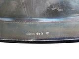 a close up of a metal object on a white surface