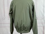 jacket on a mannequin stand in front of a white wall