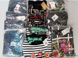 a lot of t - shirts that are on a table