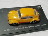 a yellow toy car sitting on top of a black box