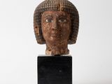 statue of a woman ' s head on a black stand