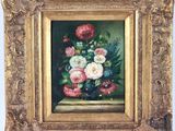 an oil painting of flowers in a gold frame on a table