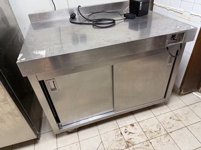 a stainless steel counter with a coffee maker on top of it
