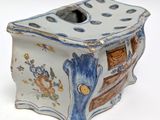 a small blue and white box with a design on it