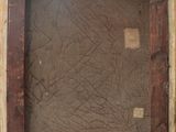 a close up of a picture of a wooden frame with a tag on it