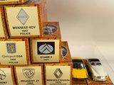 a stack of toy cars sitting on top of a pile of boxes