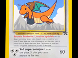 pokemon card with a picture of a dragon flying over a mountain