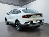 the rear end of a white suv parked in a garage