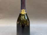 a bottle of champagne with a lion head on the top