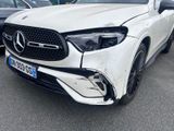 the front of a white mercedes gle parked in a parking lot