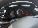 dashboard view of a car with a steering wheel and dashboard lights