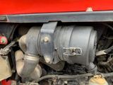 a close up view of the engine of a red truck