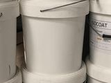 several white buckets stacked on top of each other in a warehouse