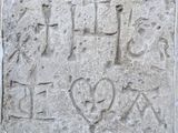 a stone block with writing on it on a wall