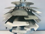 a metal object hanging from the ceiling on a table