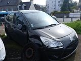 a small black car that is parked next to a white car
