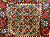 a close up of a colorful tapestry hanging on a wall