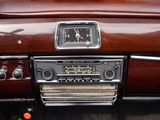 a radio in the center of a car with a clock on it