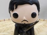 the figurine is sitting on the table with a sword in his hand