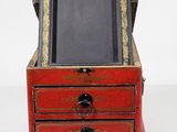 a small wooden box with a mirror in it