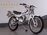 a motorcycle parked in front of the pinnacle collection sign