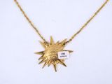 an image of a gold necklace with a starburst on it