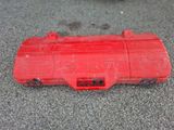 a close up of a red plastic case on the ground