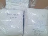 three bags of toilet paper sitting on top of a cardboard box