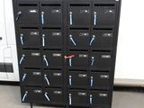 a bunch of black lockers with blue handles on them