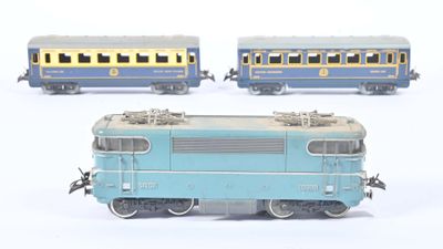 three toy trains sitting side by side on a white surface