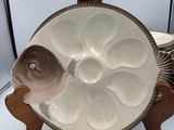 a white plate with a fish on it on a stand