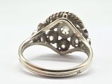 an image of a silver ring with a diamond in the center