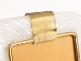 a picture of a gold and white purse with a gold ribbon around it