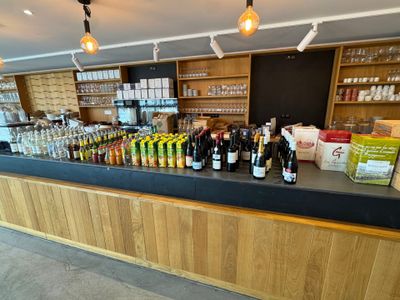 bottles of wine are lined up on a bar in a restaurant