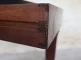 a close up of a wooden table with a drawer on it