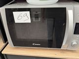 a microwave that is sitting on top of a shelf
