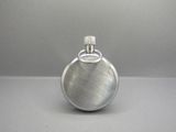 a silver flask that is sitting on a table