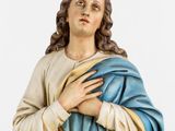 a statue of jesus holding a blue blanket on a white background
