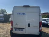the back end of a white van parked in a parking lot