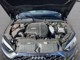 a close up of a car engine with its hood open