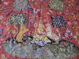 an image of a tapestry with a cat and a dog on it