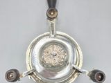 a silver plate with a black handle on it