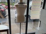a mannequin on display in the window of a store