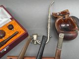 several different types of pipe smoking accessories are displayed on a table