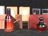 bottles of perfume are lined up on a table in front of a black background