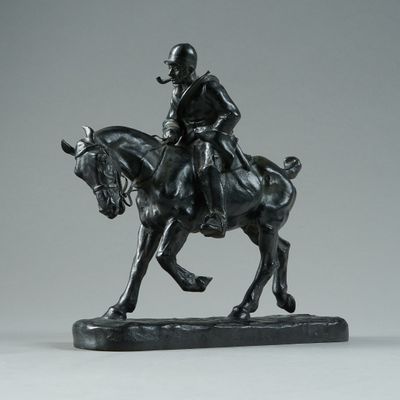 statue of a man riding a horse on a black base