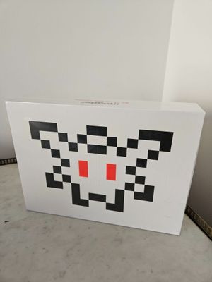 a white box with a black and red design on it