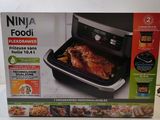 the box of the ninja foodi oven is open and ready to be cooked