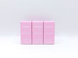 three pink boxes are stacked on top of each other on a white surface