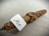 a small wooden object that has a tag on it